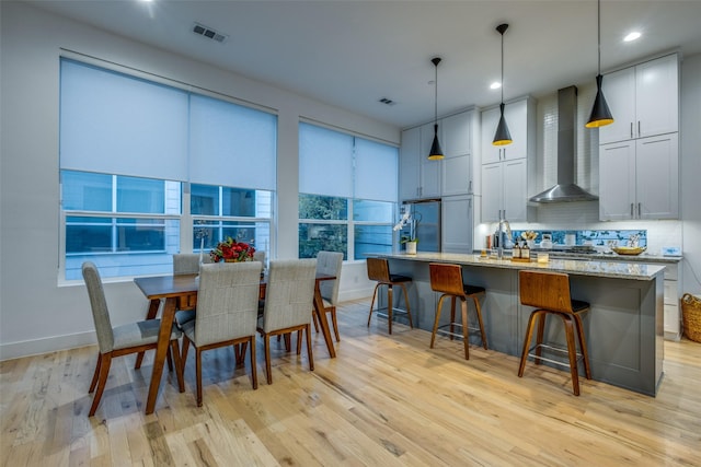 dining room featuring sink and light hardwood / wood-style floors