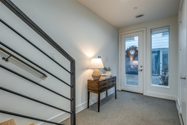 doorway with carpet floors