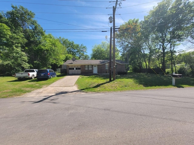 view of front facade with a garage and a front lawn