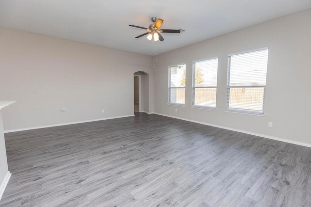 empty room with hardwood / wood-style flooring and ceiling fan