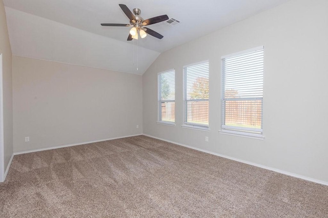 empty room with carpet flooring, ceiling fan, and lofted ceiling