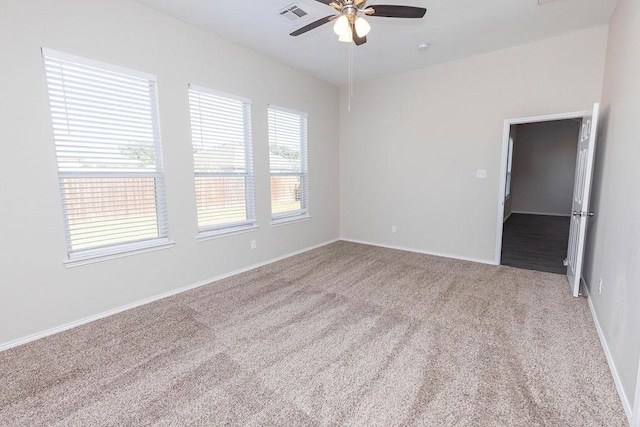 spare room with carpet floors and ceiling fan