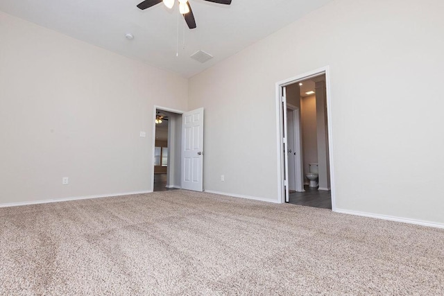 carpeted spare room featuring ceiling fan