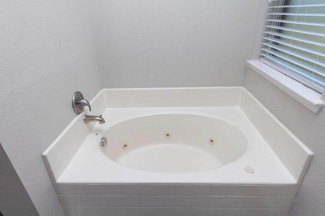 bathroom with tiled tub