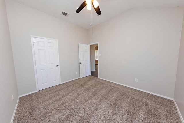 spare room with carpet floors, high vaulted ceiling, and ceiling fan