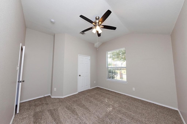 unfurnished room with vaulted ceiling, carpet floors, and ceiling fan