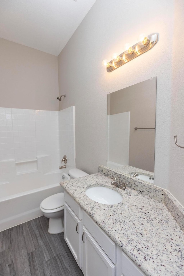 full bathroom with vanity, toilet, shower / bathing tub combination, and hardwood / wood-style flooring