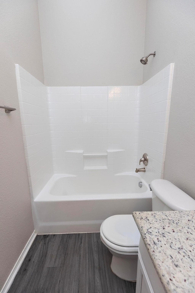 full bathroom featuring vanity, hardwood / wood-style floors, shower / washtub combination, and toilet