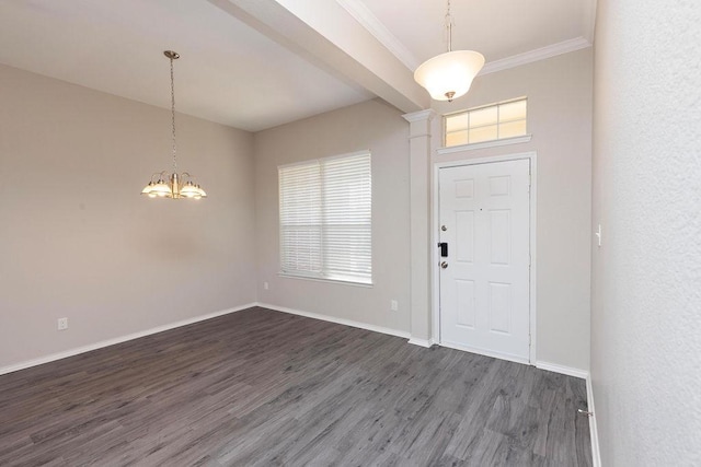 foyer with a notable chandelier, crown molding, and dark hardwood / wood-style floors