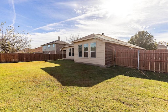 rear view of house with a lawn