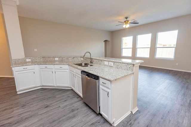 kitchen with stainless steel dishwasher, white cabinets, kitchen peninsula, and sink