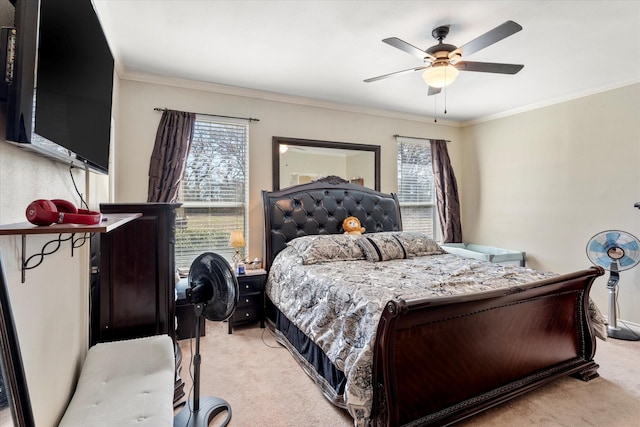 bedroom featuring light colored carpet, multiple windows, crown molding, and ceiling fan