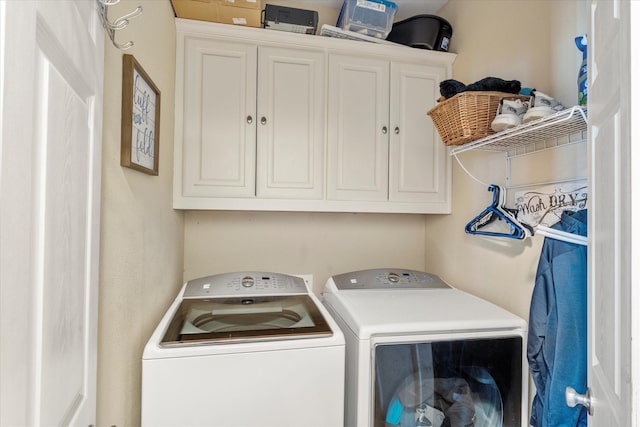 washroom featuring cabinets and washing machine and dryer