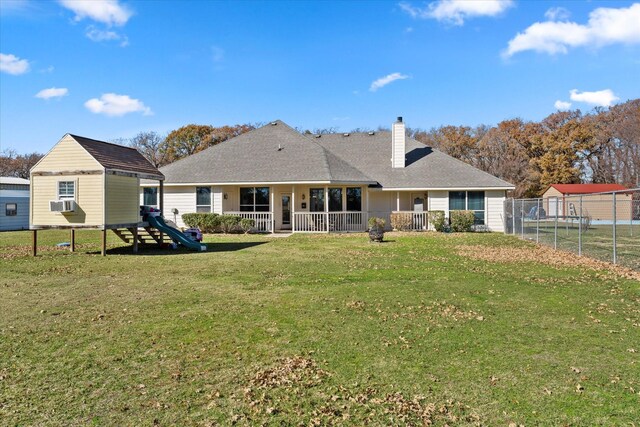 back of house featuring a lawn