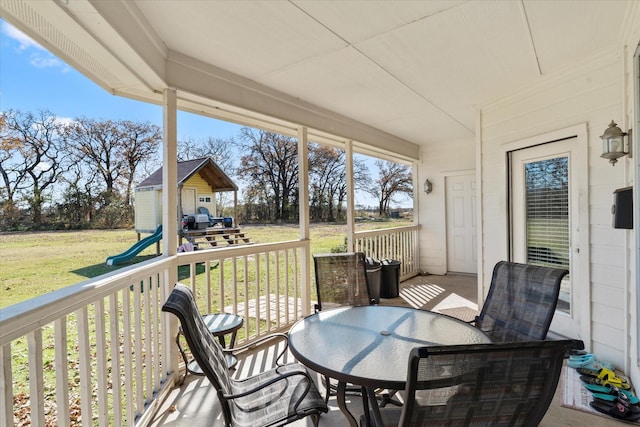 wooden deck featuring a lawn and an outdoor structure