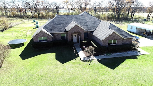 view of front facade featuring a trampoline and a front lawn