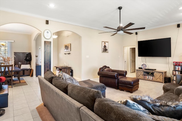 tiled living room featuring ceiling fan and ornamental molding