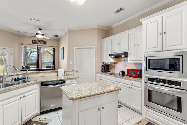 kitchen featuring white cabinetry, sink, light tile patterned flooring, and black appliances