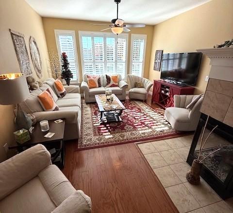 living room featuring light hardwood / wood-style flooring and ceiling fan