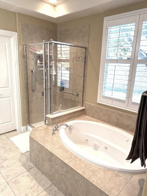 bathroom with shower with separate bathtub