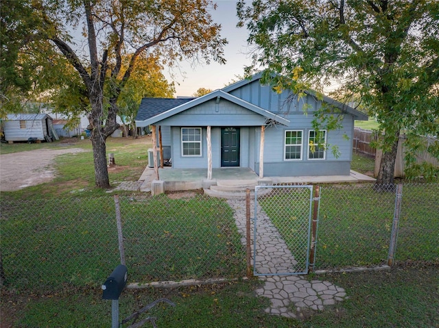 bungalow-style home with a lawn and a porch