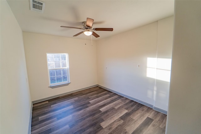 spare room featuring ceiling fan and dark hardwood / wood-style floors