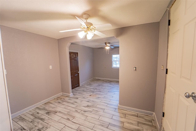 empty room featuring ceiling fan and light wood-type flooring