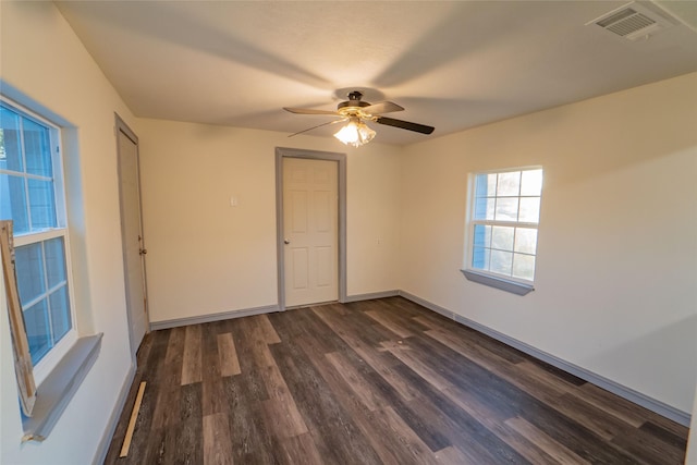 unfurnished room with dark hardwood / wood-style floors and ceiling fan