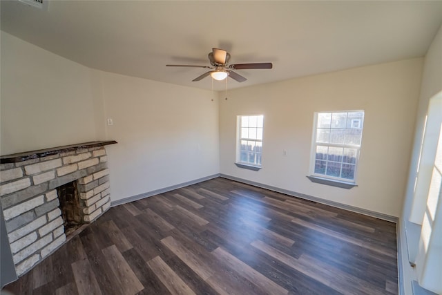 unfurnished living room with dark hardwood / wood-style flooring and ceiling fan