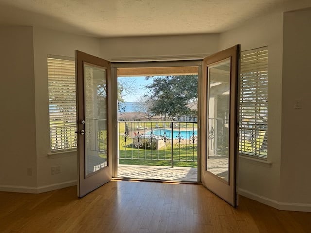 doorway with french doors and hardwood / wood-style flooring