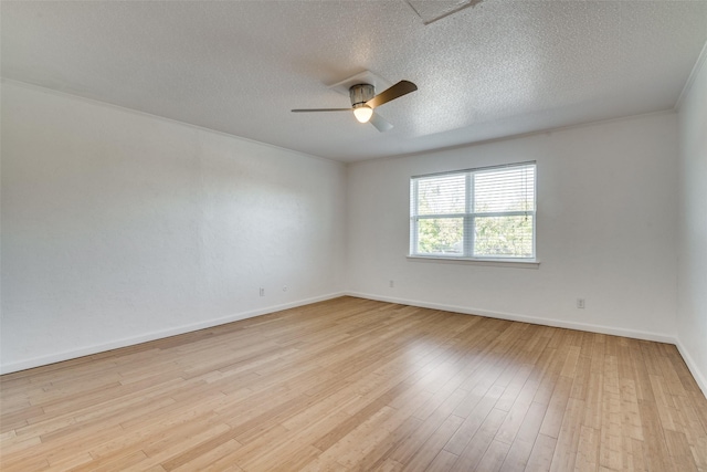 spare room featuring ceiling fan, a textured ceiling, and light wood-type flooring