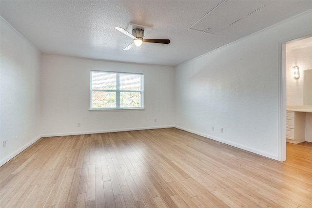 spare room featuring ceiling fan, crown molding, a textured ceiling, and light wood-type flooring