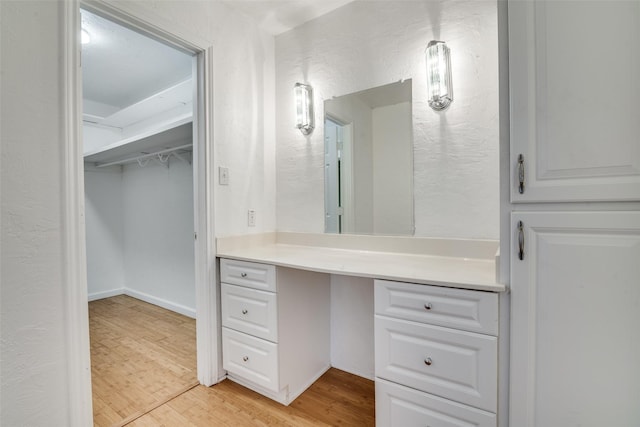 bathroom with hardwood / wood-style flooring and vanity