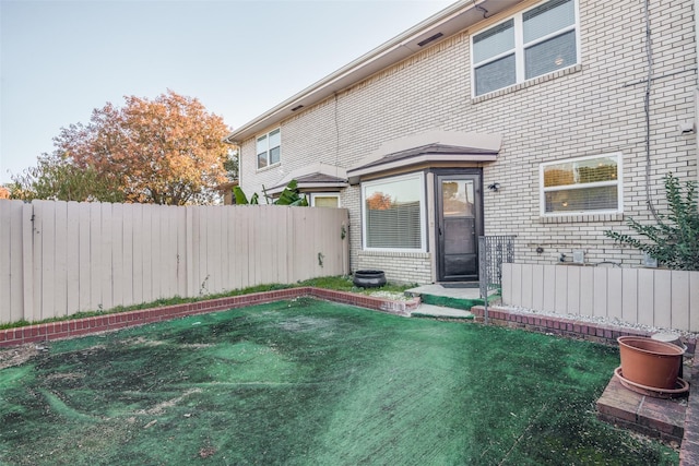 rear view of house with a lawn