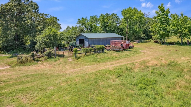 view of yard featuring a rural view and an outdoor structure