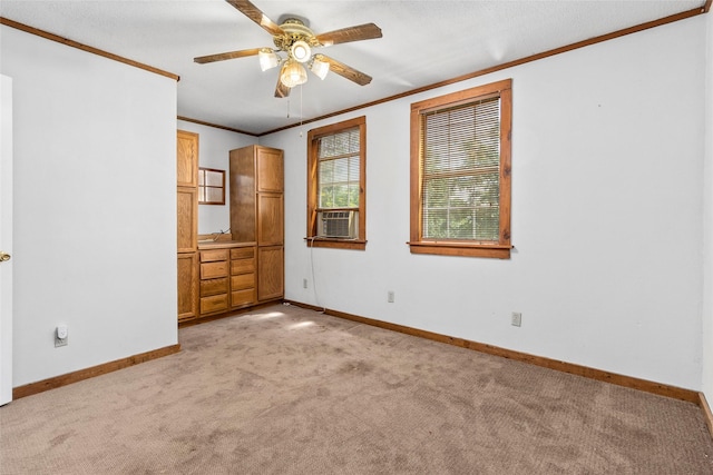 unfurnished bedroom featuring crown molding, light colored carpet, and ceiling fan