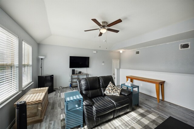 living room with dark hardwood / wood-style flooring, ceiling fan, and lofted ceiling