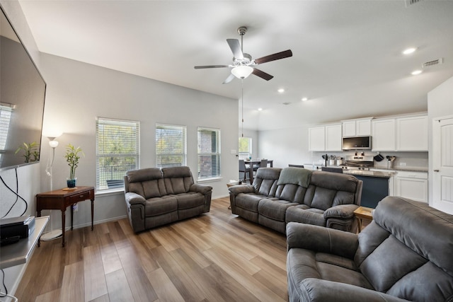 living room with ceiling fan and light hardwood / wood-style floors