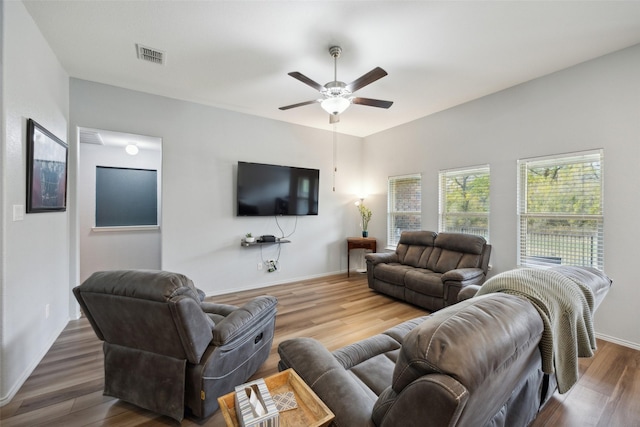 living room with wood-type flooring and ceiling fan