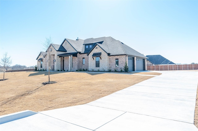 view of front of property featuring a garage and a front yard