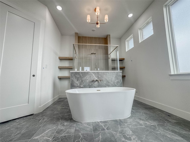 bathroom featuring a notable chandelier and shower with separate bathtub