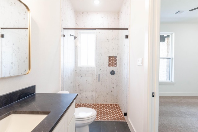 bathroom featuring tile patterned flooring, vanity, toilet, and walk in shower