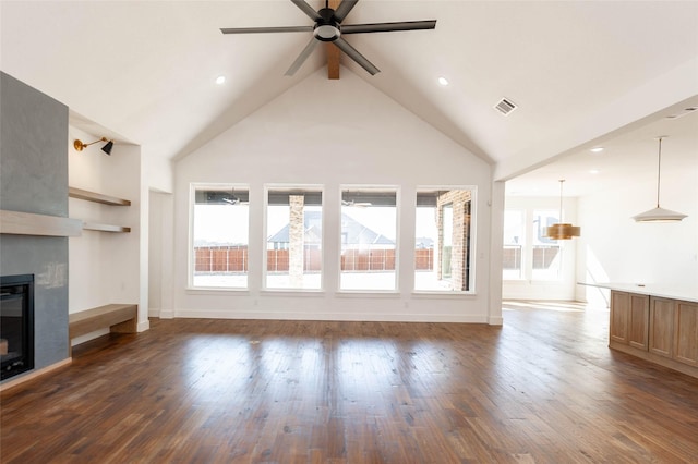 unfurnished living room featuring ceiling fan, high vaulted ceiling, a large fireplace, and dark hardwood / wood-style flooring