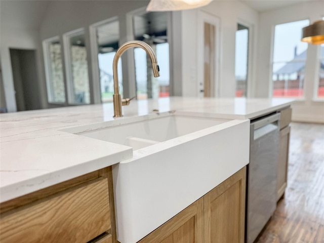 kitchen with dishwasher, light hardwood / wood-style floors, and sink