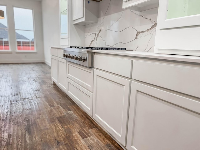 kitchen with white cabinets, dark hardwood / wood-style flooring, and stainless steel gas stovetop