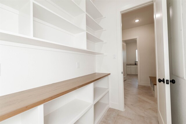 kitchen with white cabinetry, dark wood-type flooring, and stainless steel gas stovetop