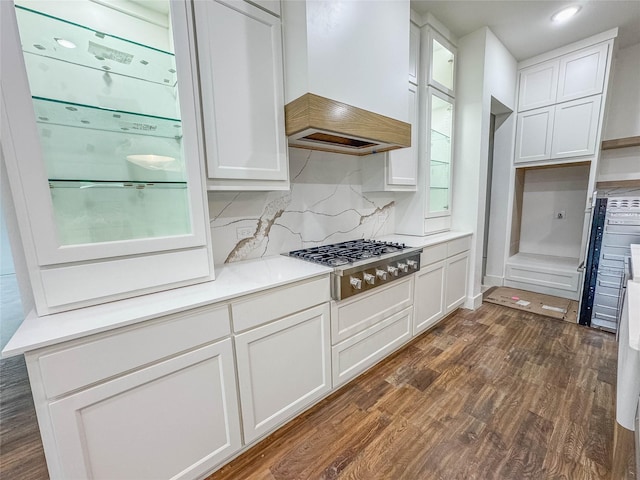 kitchen with white cabinetry, dark wood-type flooring, custom exhaust hood, and stainless steel gas stovetop