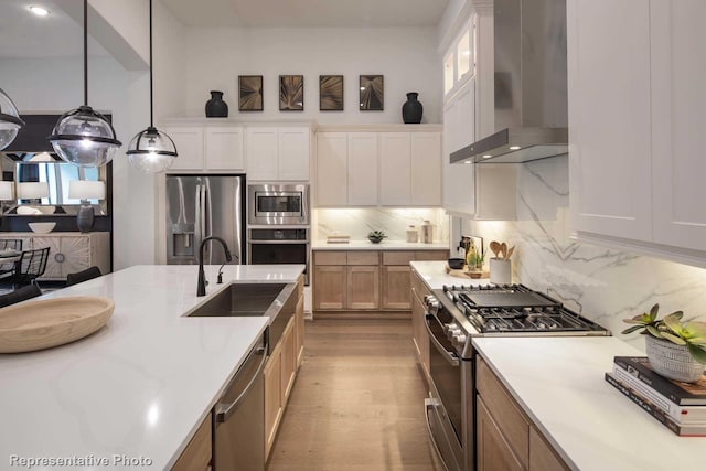 4121 Buffalo Clover Dr, Aubrey, TX 76227 - kitchen with wall chimney range hood, appliances with stainless steel finishes, light countertops, decorative backsplash, and recessed lighting