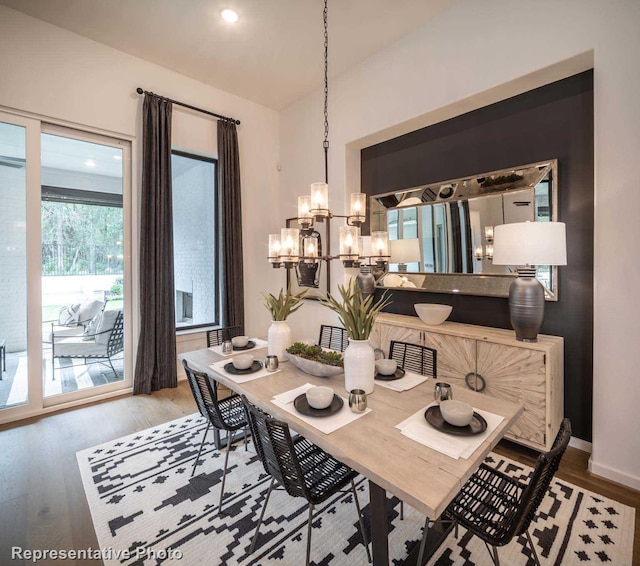 4121 Buffalo Clover Dr, Aubrey, TX 76227 - dining space with a chandelier, wood finished floors, and vaulted ceiling