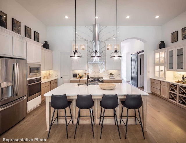 4121 Buffalo Clover Dr, Aubrey, TX 76227 - kitchen with appliances with stainless steel finishes, arched walkways, decorative backsplash, and recessed lighting